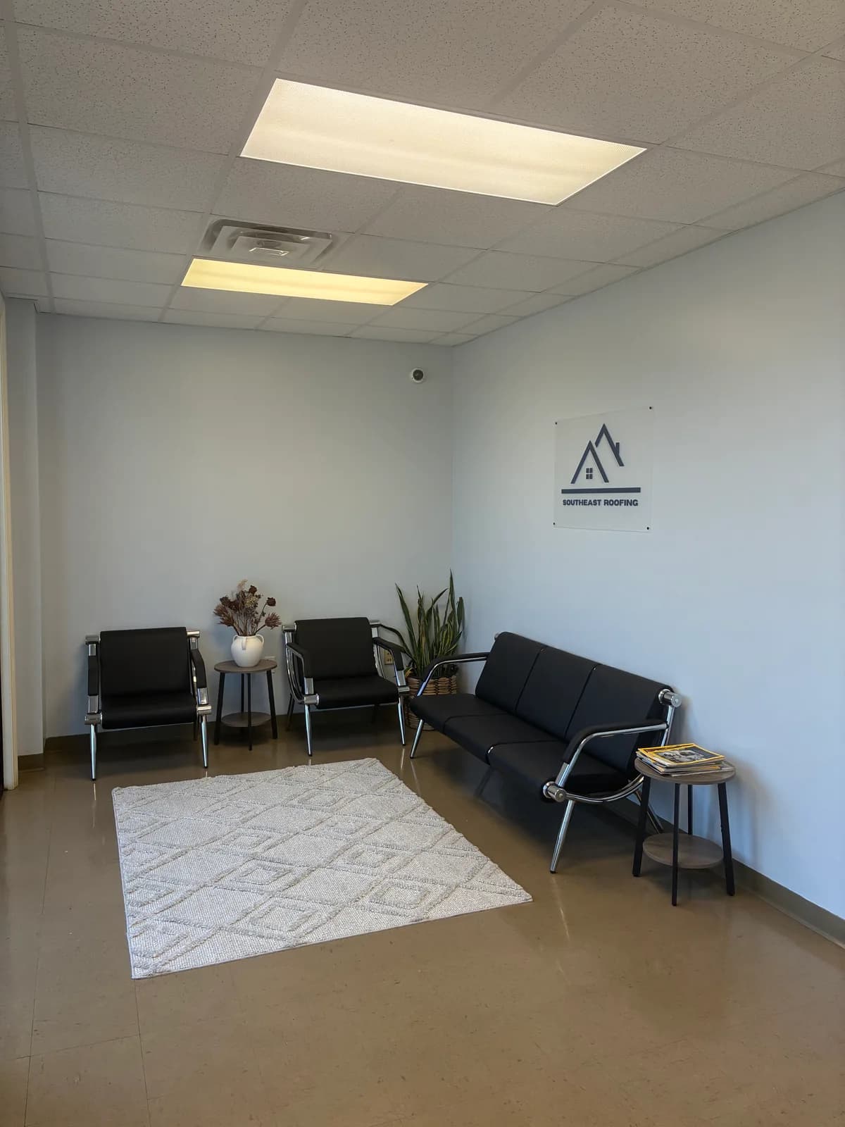 The branded reception and waiting area inside Southeast Roofing's Hattiesburg office.