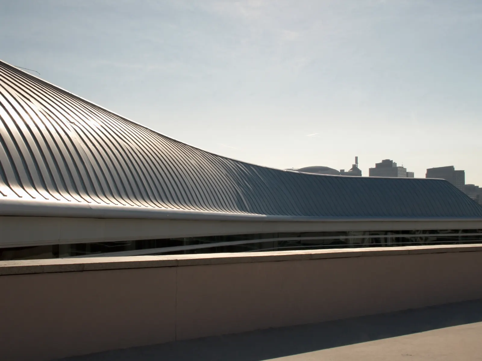 Curved architectural standing seam metal roof on a modern commercial building
