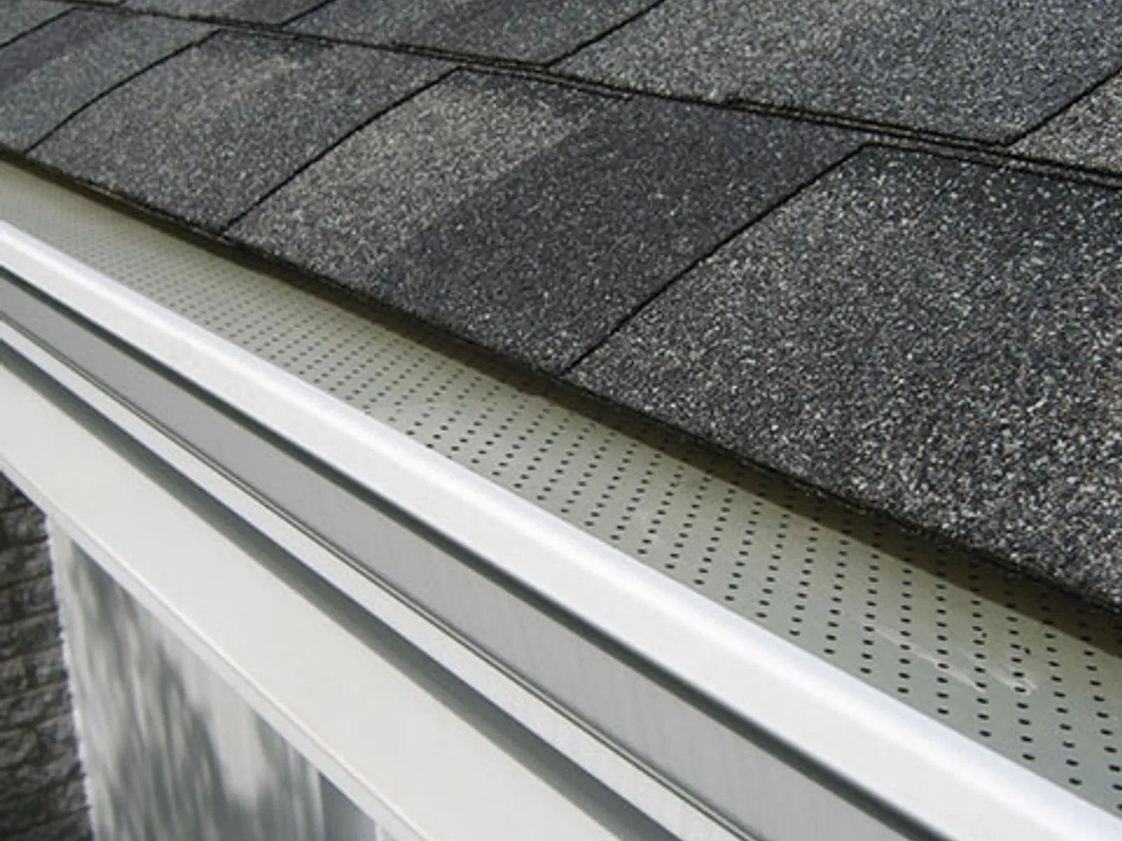 New micro-mesh gutter guard installed on a clean gutter and shingle roof