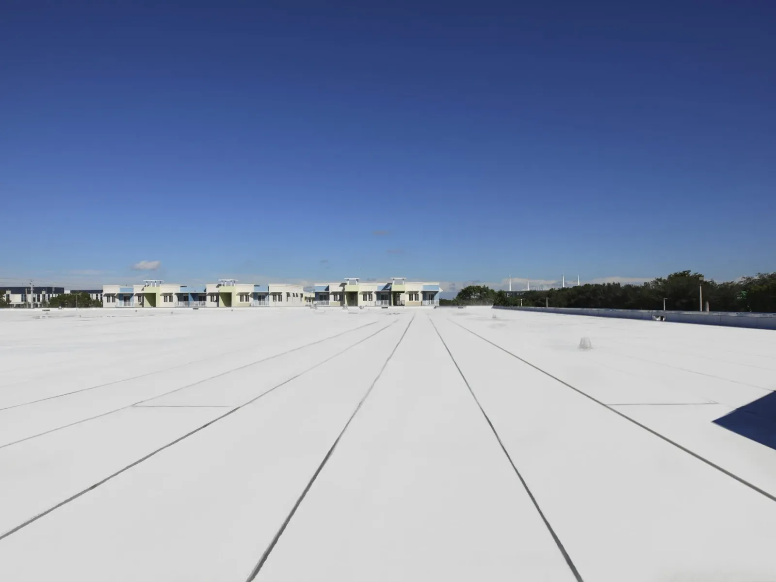 Modified bitumen membrane roof with a reflective cap sheet on a commercial building
