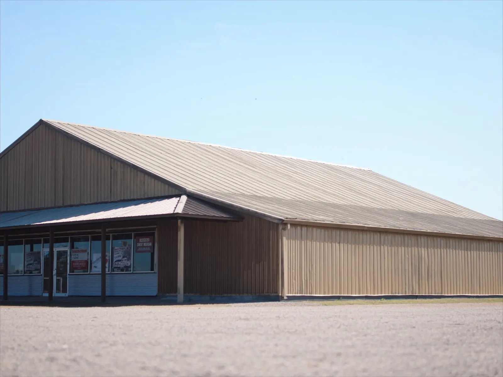 Metal building with tan PBR panel roof and walls