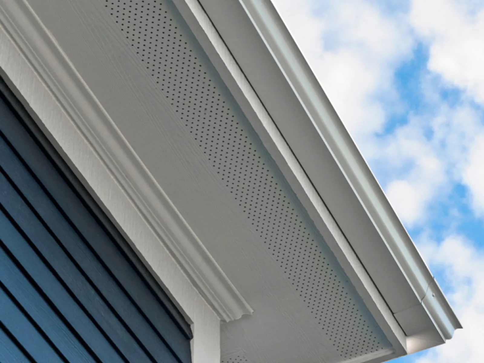 Clean painted wood soffit under a home's eave