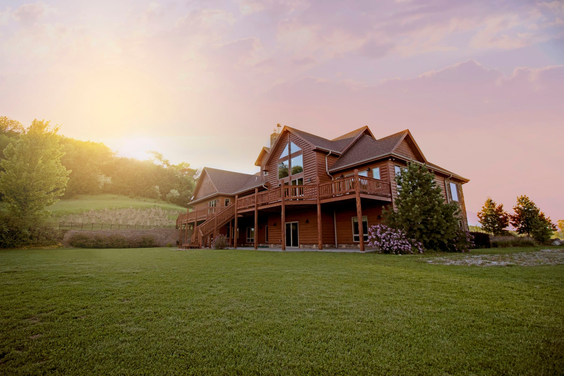 Home with a brown asphalt shingle roof at golden hour