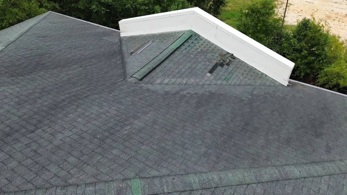 Missing shingles along a hip where the wind stripped the course away