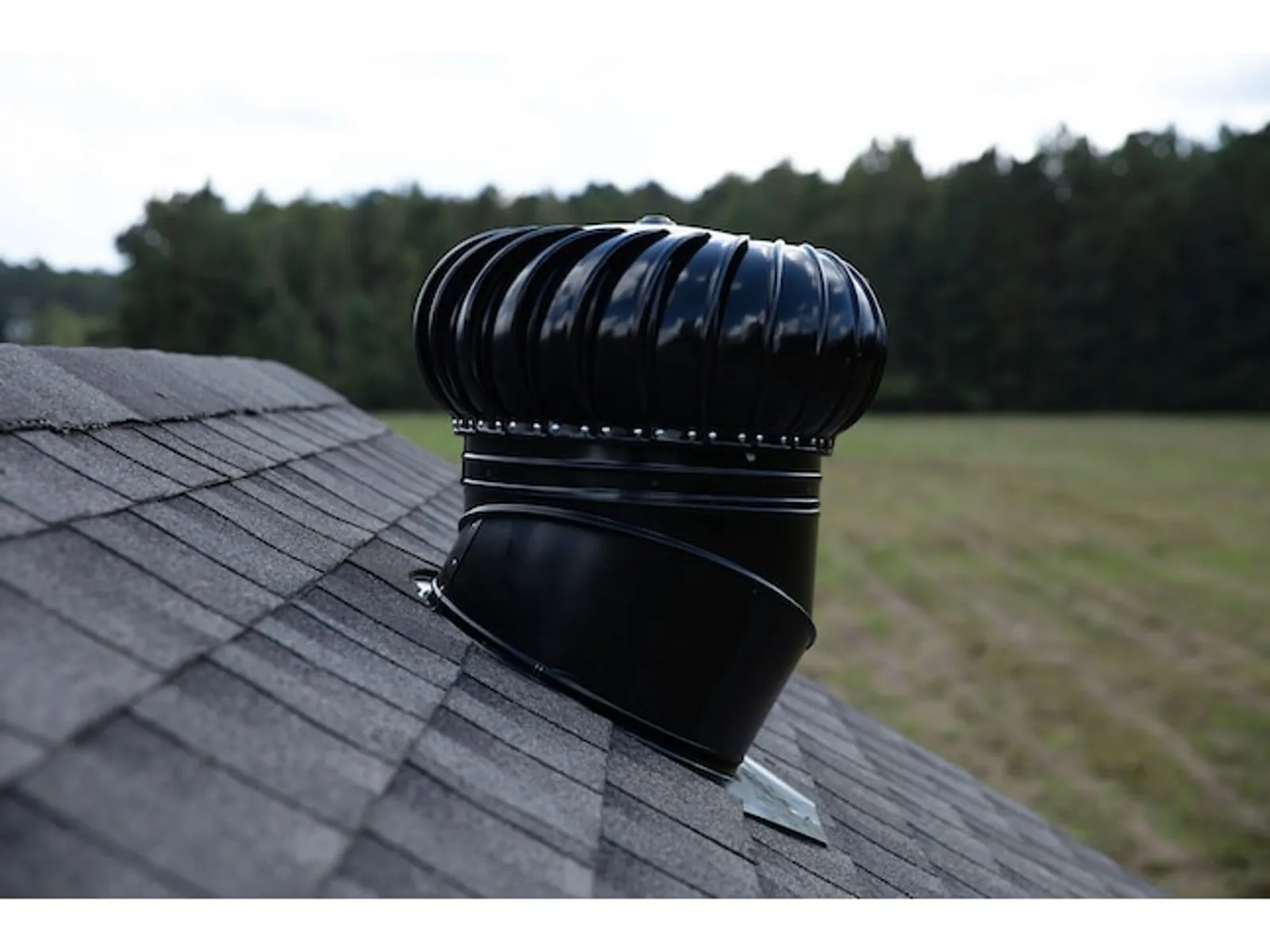 Wind-driven turbine attic vent on a shingle roof