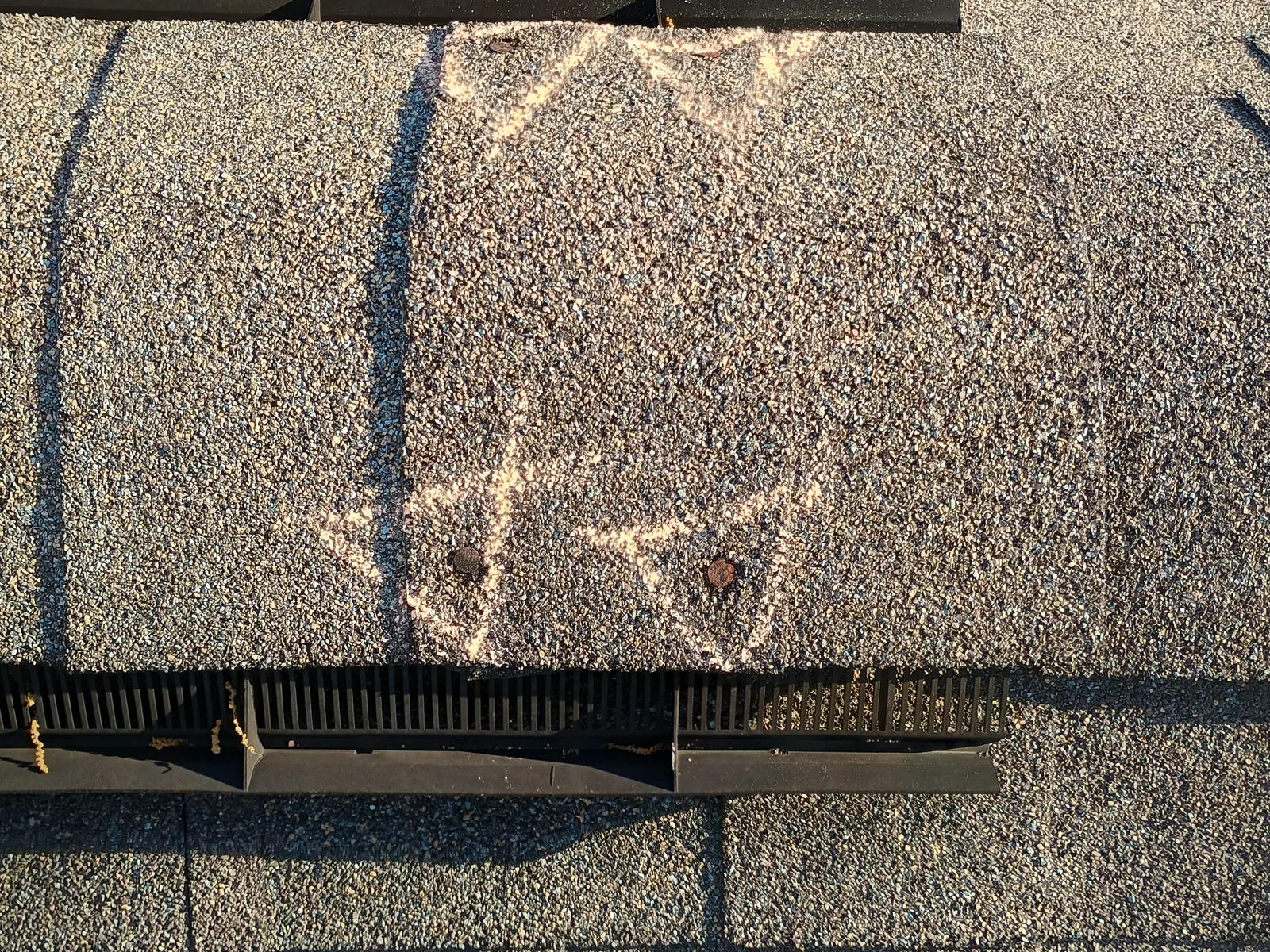 Nail pops backing out through the shingles documented during a Southeast Roofing inspection in Magee, Mississippi.
