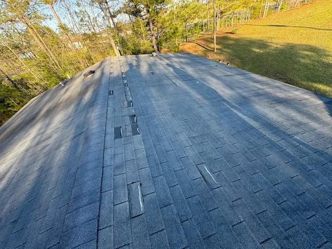 Missing shingles from wind damage documented during a Southeast Roofing inspection in Petal, Mississippi.