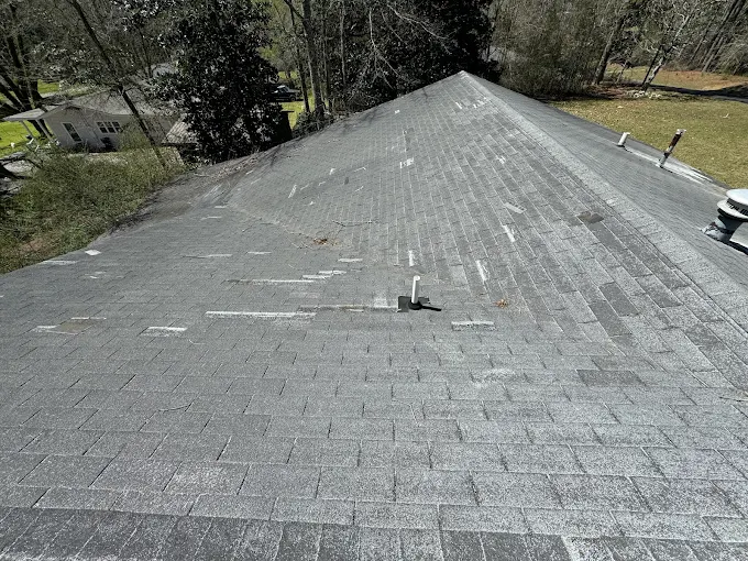 Missing shingles from wind damage documented during a Southeast Roofing inspection in Purvis, Mississippi.